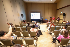 session room with person raising their hand