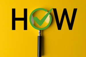 HOW with magnifying glass and check mark