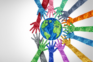 A paper mache globe surrounded by paper mache hands