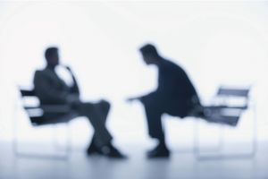 Two individuals talking at a distance