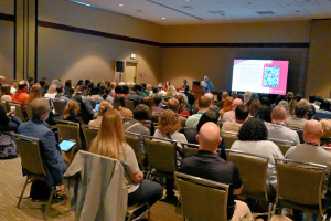 session full of people with large screen