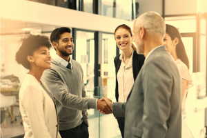 A group of people shaking hands and talking