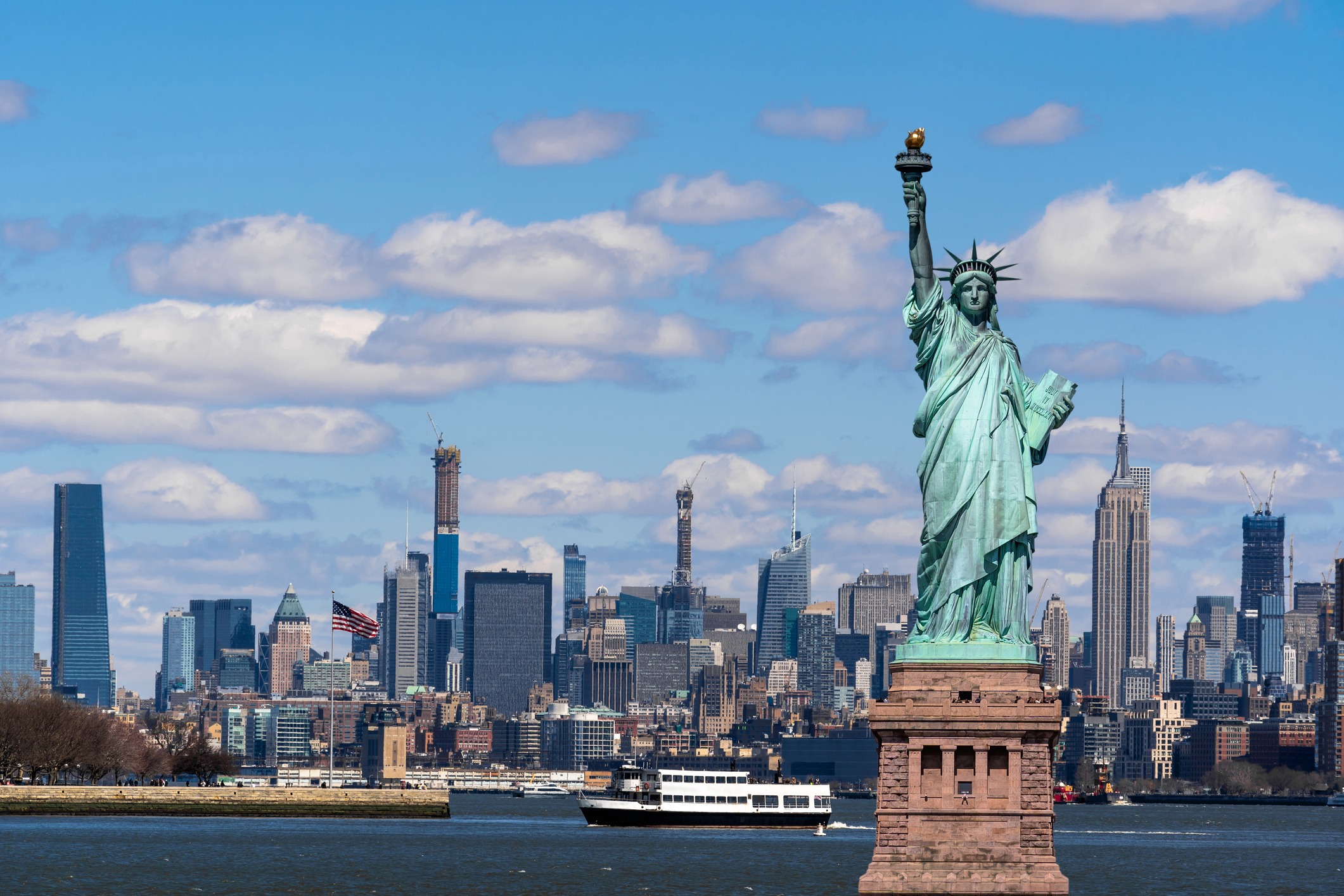 statute of liberty with the New York city skyline visible in the background