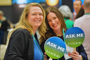 Volunteers holding "Ask Me" signs