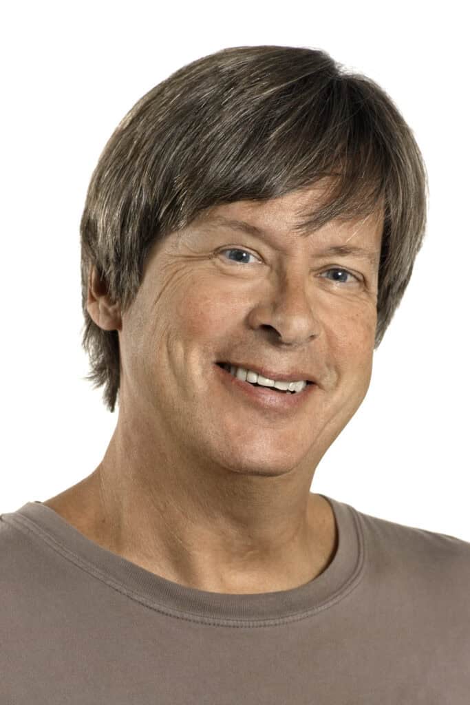 Portrait of a smiling woman with short brown hair against a white background