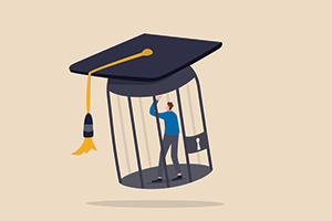 student wearing a blue shirt trapped in a cage with a giant graduation cap on top of the cage