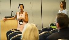 Female presenting from in front of a podium.