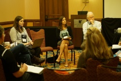 People seated in a circle as part of a breakout session.