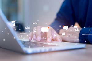 hands typing on laptop with email and messaging symbols floating over them