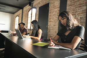 Group of students working at a table.
