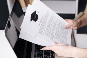 Individual holding financial aid documents.