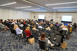 Audience seated in a conference room during a presentation