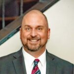 Smiling man in a suit and tie for a professional headshot