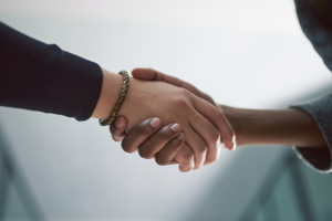 Photograph of two individuals shaking hands.