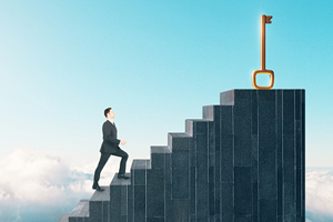 male climbs staircase towards a golden key which resides at the top