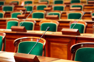 Empty courtroom seats with microphones on the desks