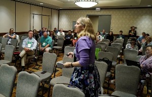 Attendees of an AACRAO breakout session sitting in a conference space.