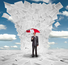 Male holding a red umbrella to protect himself from a tornado of papers.