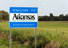 Photo of a "welcome to Arkansas" highway sign.