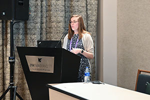 Katie Brown presenting from behind a podium