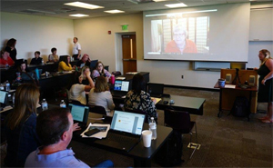 Classroom lecture with a presenter at the front and students seated watching