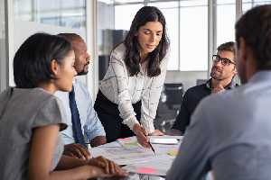 Business women leading a meeting of a team of professionals.