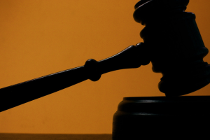 Illustration of a gavel on an orange background.
