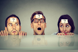 three people with question marks on their heads