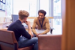 male college student meeting with male college counselor