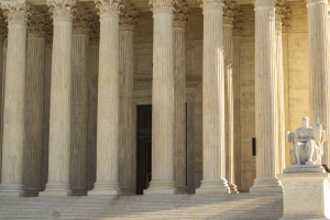 Statue in a colonnaded hall with tall marble columns