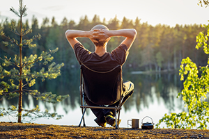 Individual relaxing near a large body of water.