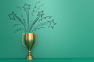 Golden award trophy on light green background.