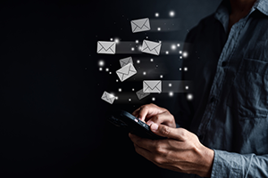 Individual using a phone to send messages.