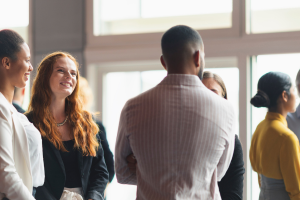 People talking and networking in a bright office meeting room