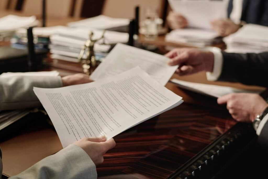 two pairs of hands exchanging written documents