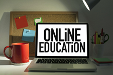Laptop with the words "online education" visible on the display.