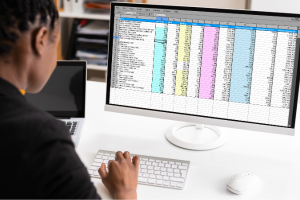 Individual working on spreadsheets.