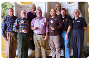 group of people wearing business casual clothing pose together for a photo