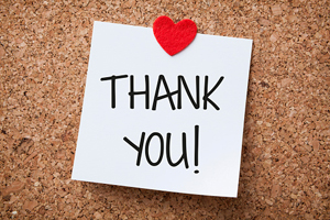 cork board with a note saying "Thank You!" pinned to the board with a heart sticker