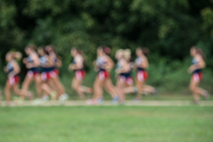 Group of athletes running on a track.