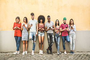 Group of students staring at phones.