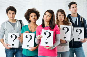 diverse group of students holding questions marks