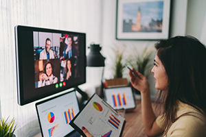 Young woman attending a virtual meeting.
