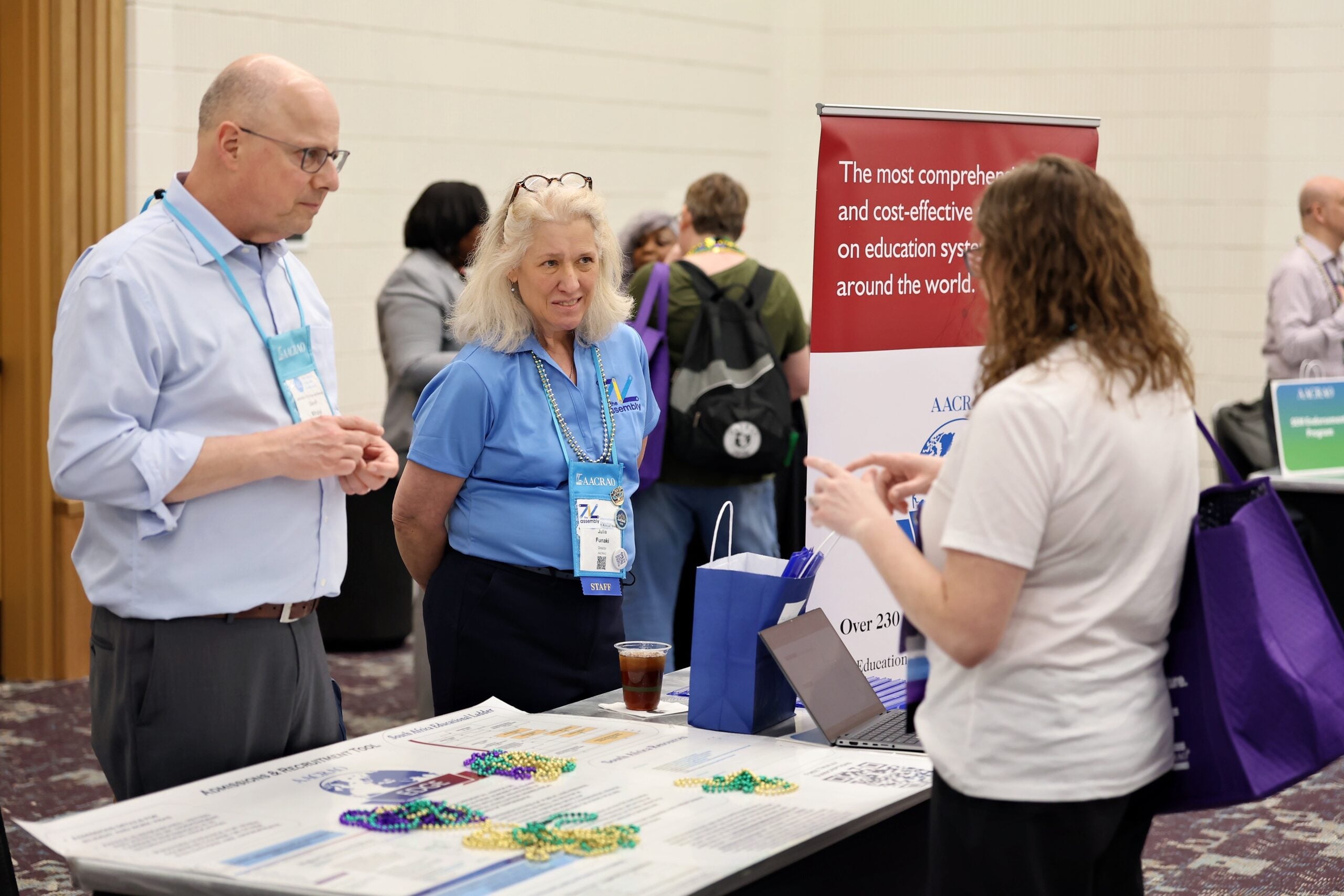 AACRAO staff speak to a member at the Experience AACRAO event at the 2026 Annual Meeting
