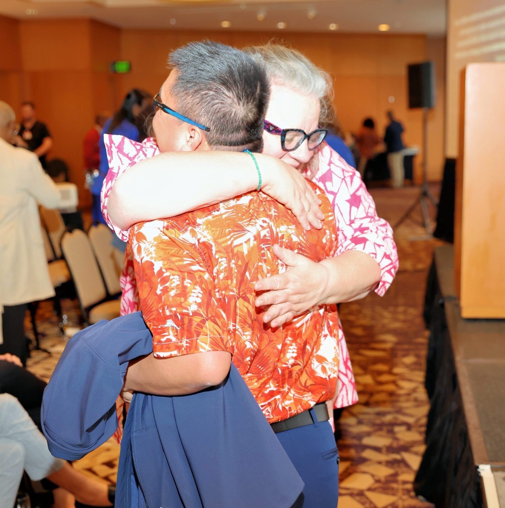 Two AACRAO members hug at the Honorees Reception at the 2025 Annual Meeting