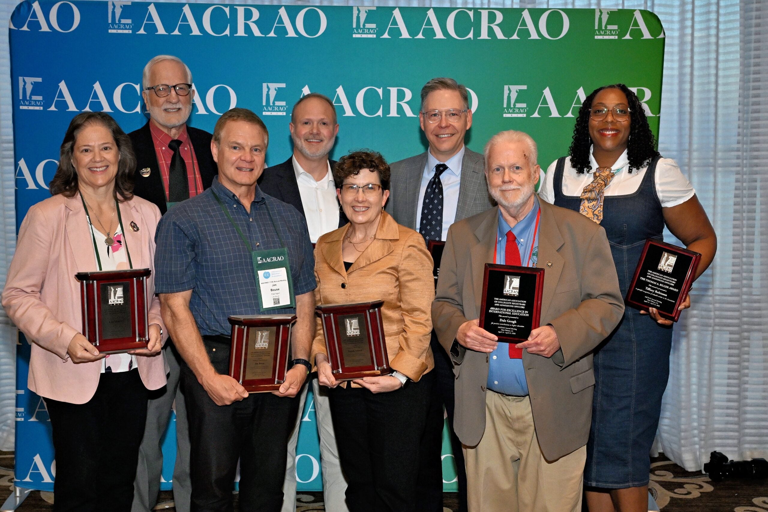 8 AACRAO Award Winners standing with their plaques