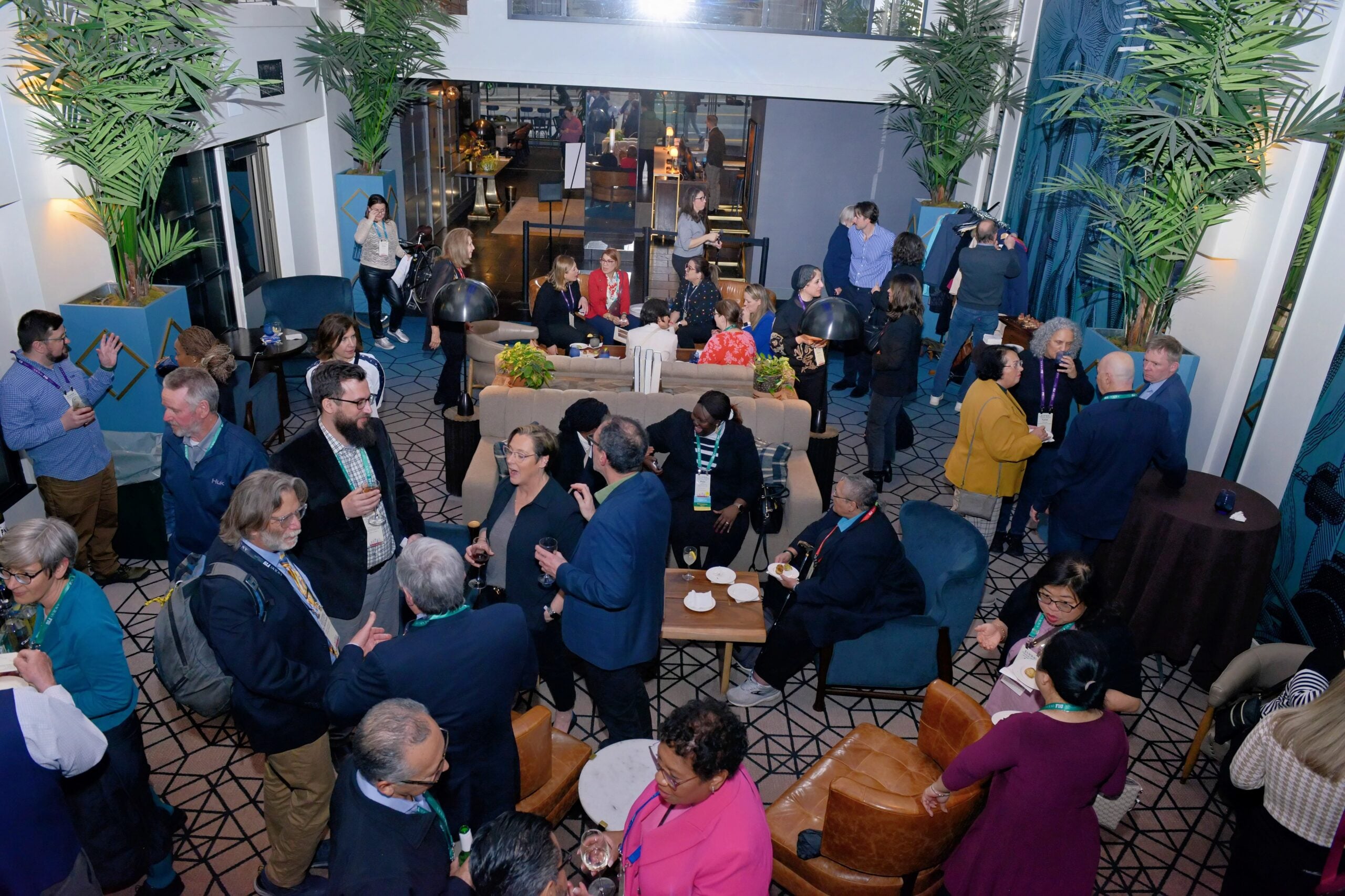 Group milling about at the international dinner during Annual Meeting 2025