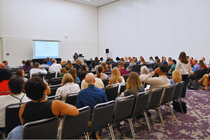 View of crowded AM26 session from back of the room