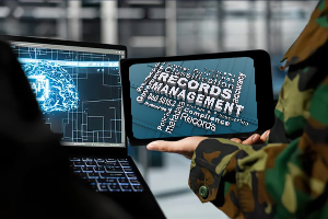 Military personnel holding a screen with word cloud of academic records management functions