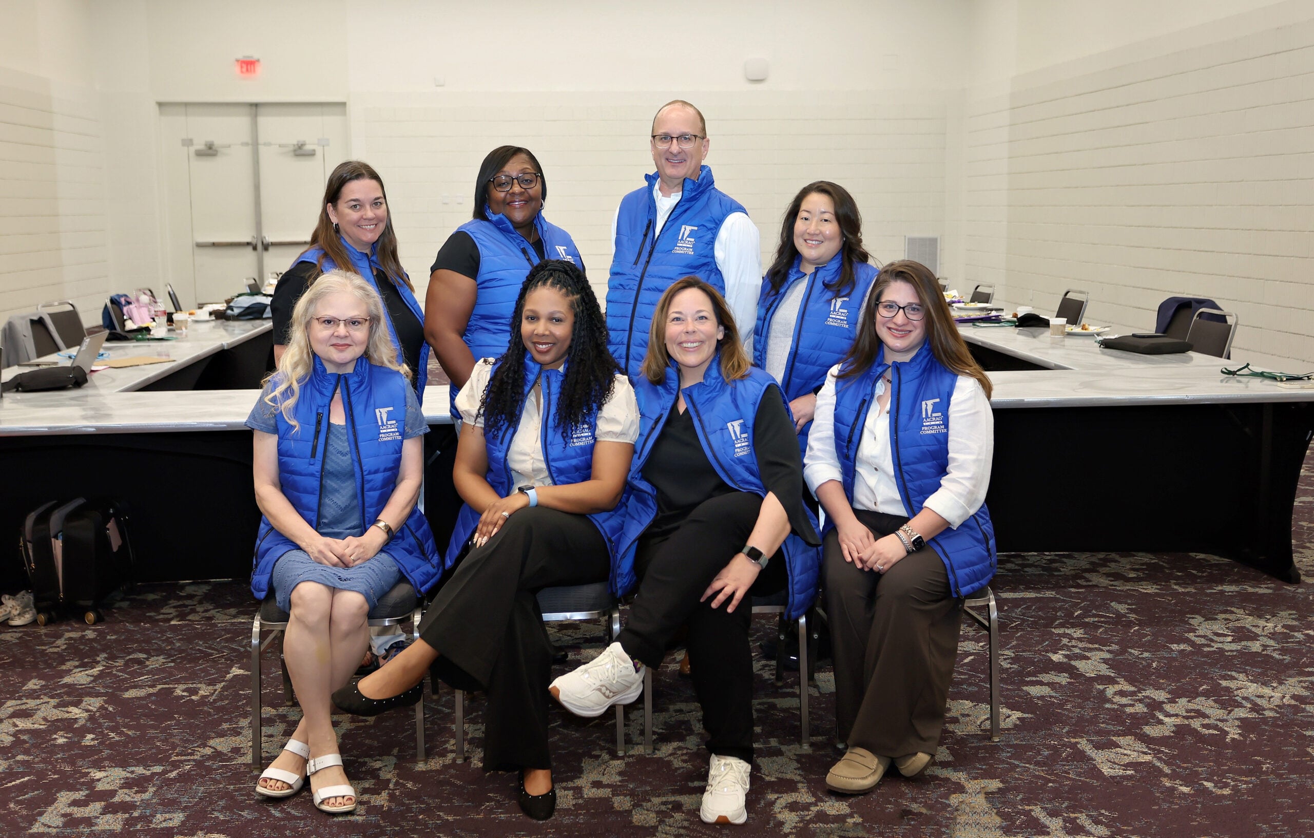 8 AACRAO Program Committee members in blue puffer vests